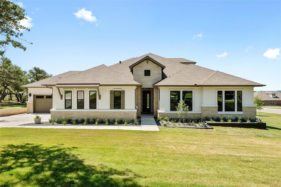 View of front facade featuring stone siding, an a