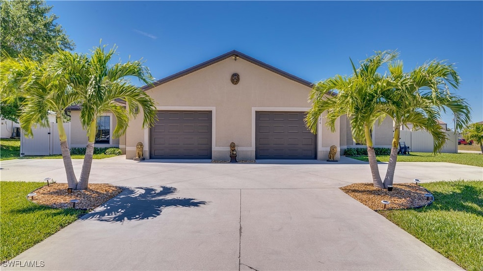 View of front of property featuring driveway, stucco siding, and an attached garage