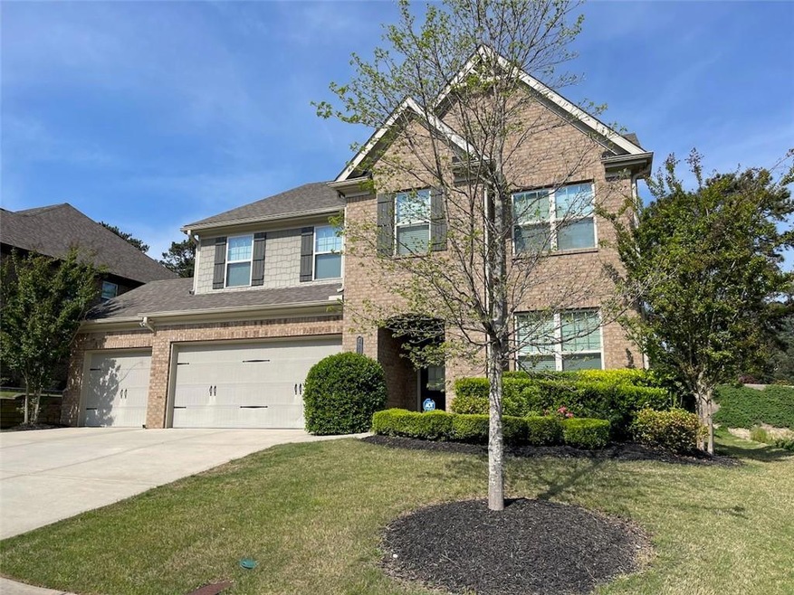 View of front facade with a front lawn and a garage