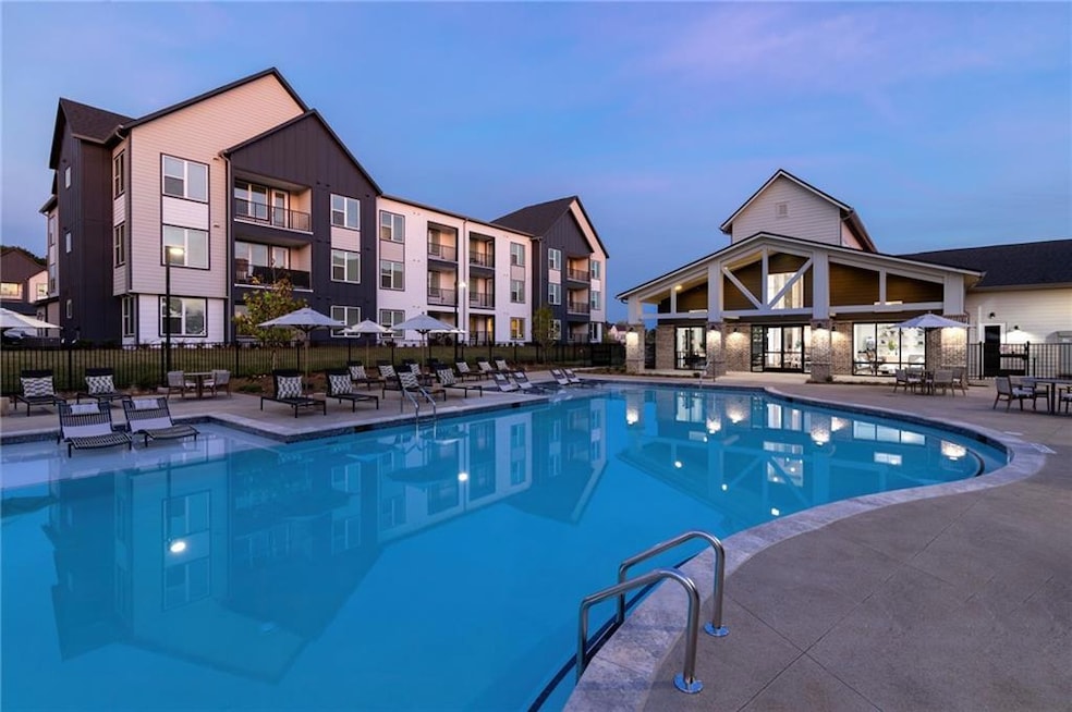 Pool at dusk featuring a patio