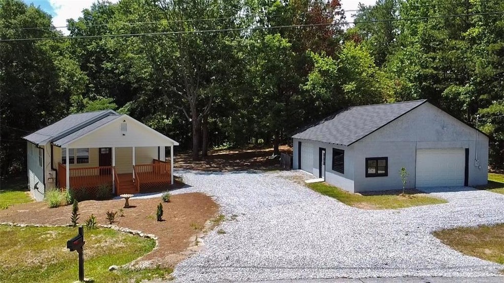 View of front of home with a garage and an outdoor