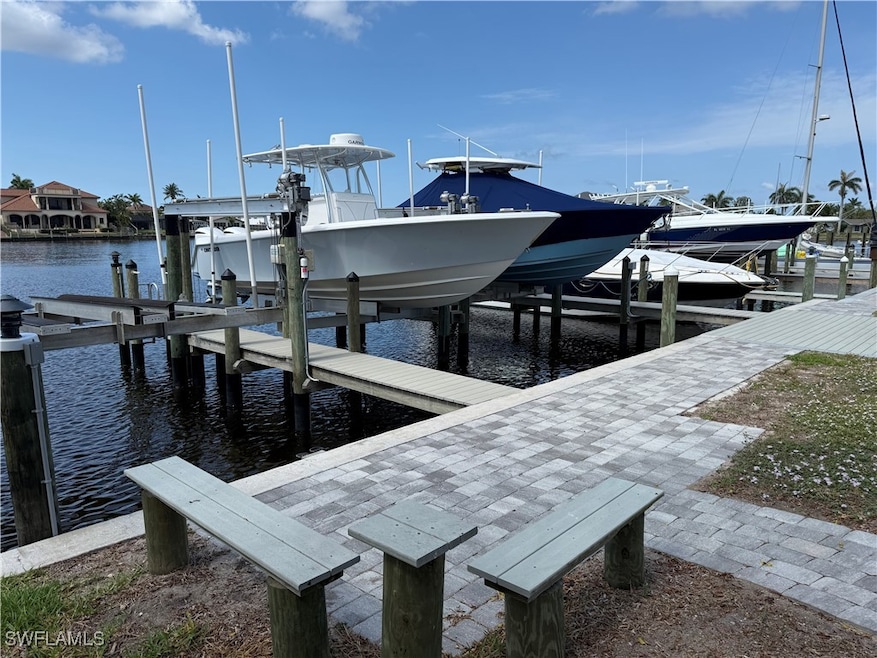 Dock area with boat lift and a water view