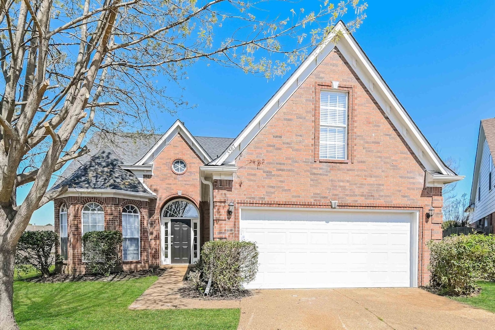 Traditional-style house with a front lawn, brick s