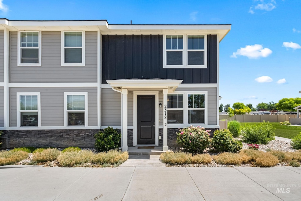 View of front of home featuring board and batten siding and stone siding