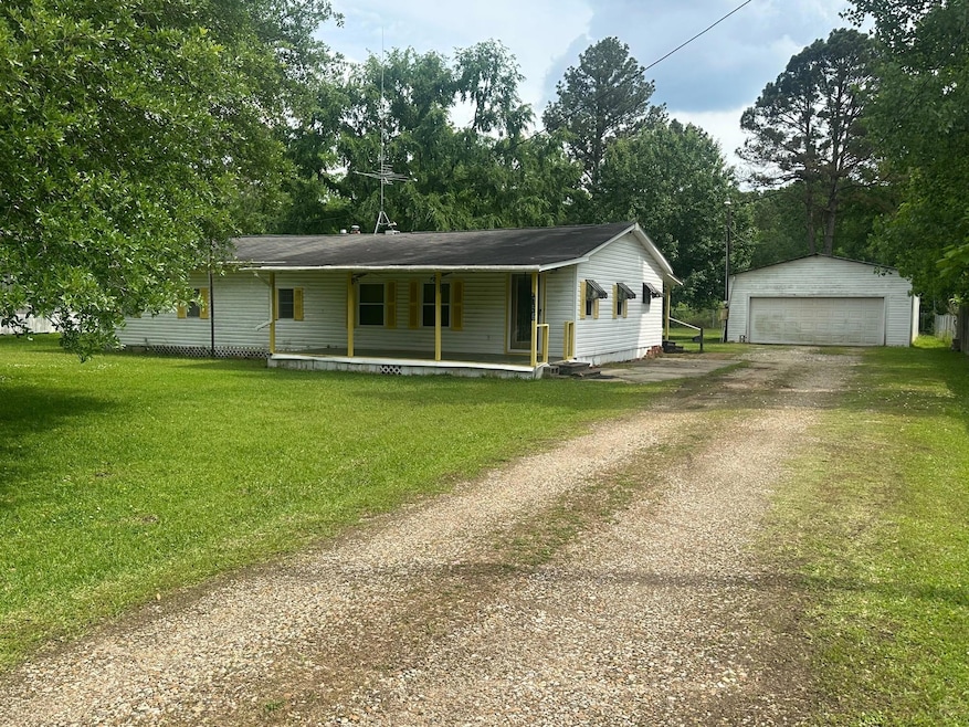 View of front facade with a detached garage, a por