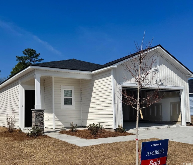 View of side of home with an attached garage and d