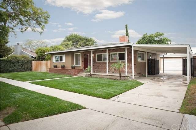 Front of house. Large front porch. Covered carport