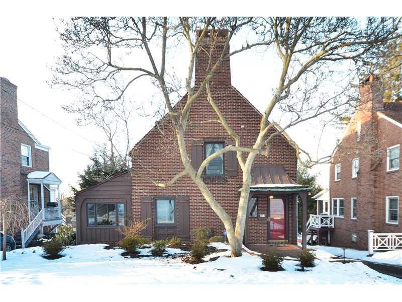 Exterior Front. Level entry brick Tudor with cover
