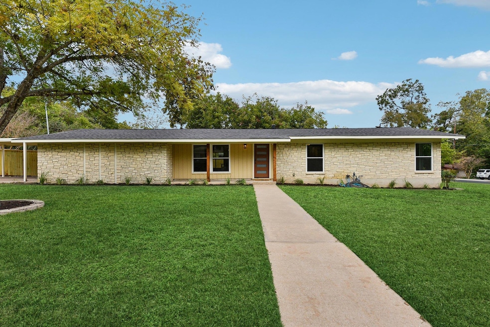 Single story home featuring a front lawn and ston