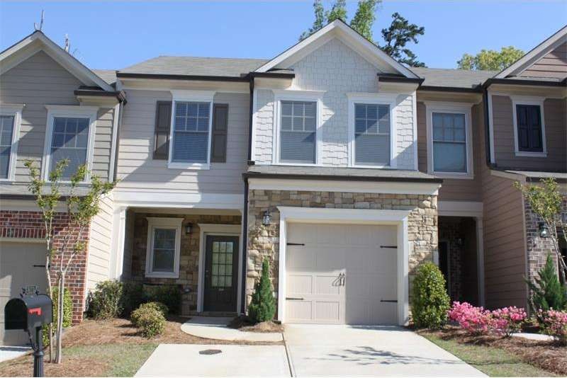 Front with driveway and parking pad.