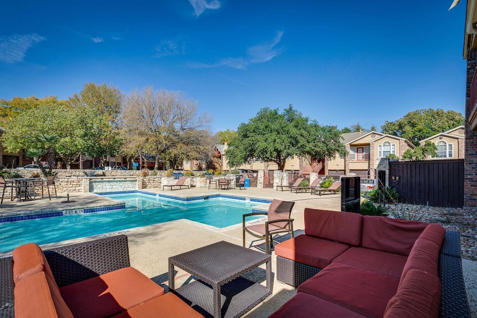 Community pool with a patio area, outdoor lounge area, and a residential view