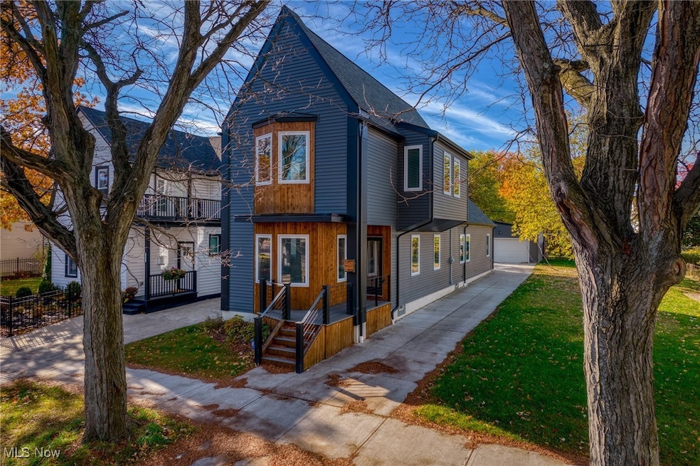 View of front of property featuring a front lawn and roof with shingles