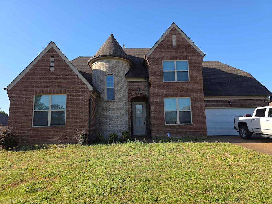 View of front facade featuring brick siding, an at
