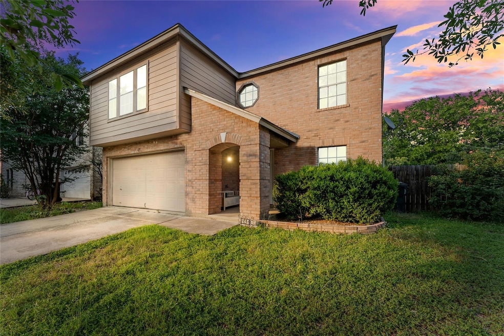 View of front facade featuring brick siding, driv