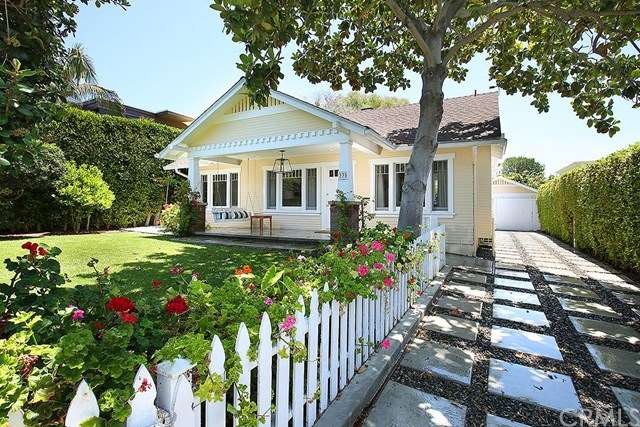 Large front porch entry and hedged private front y
