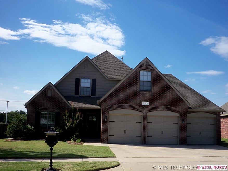 Front of home professionally landscaped with 3 car