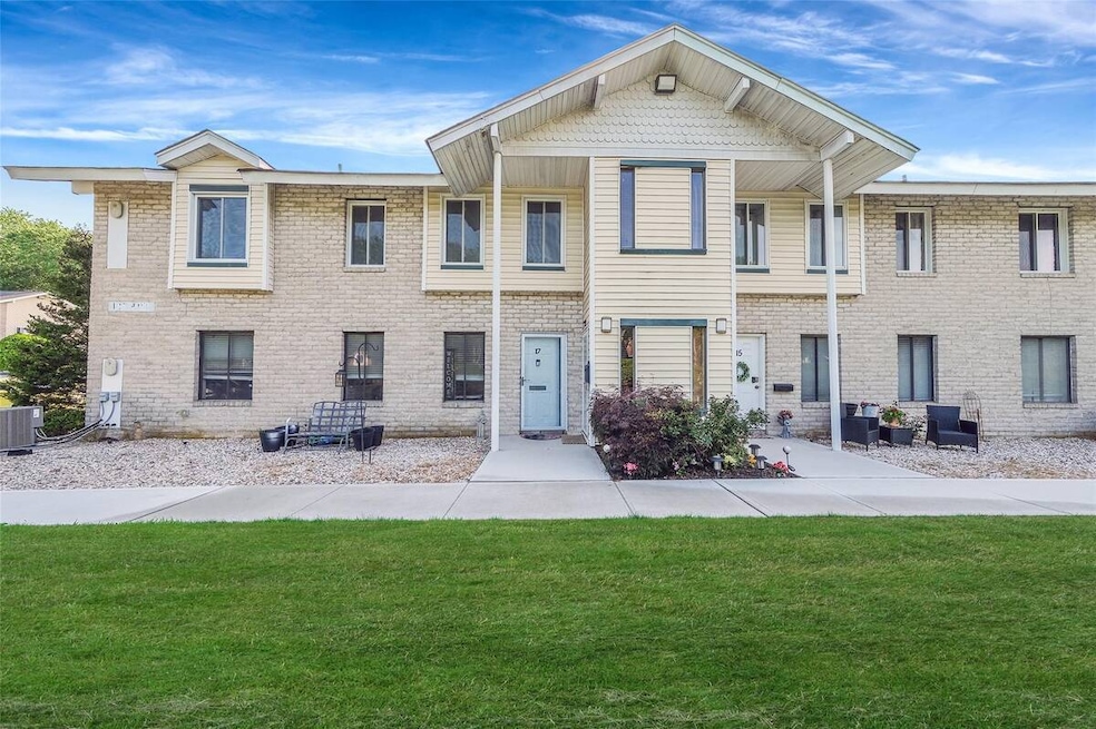 View of front of home with a front lawn and brick siding