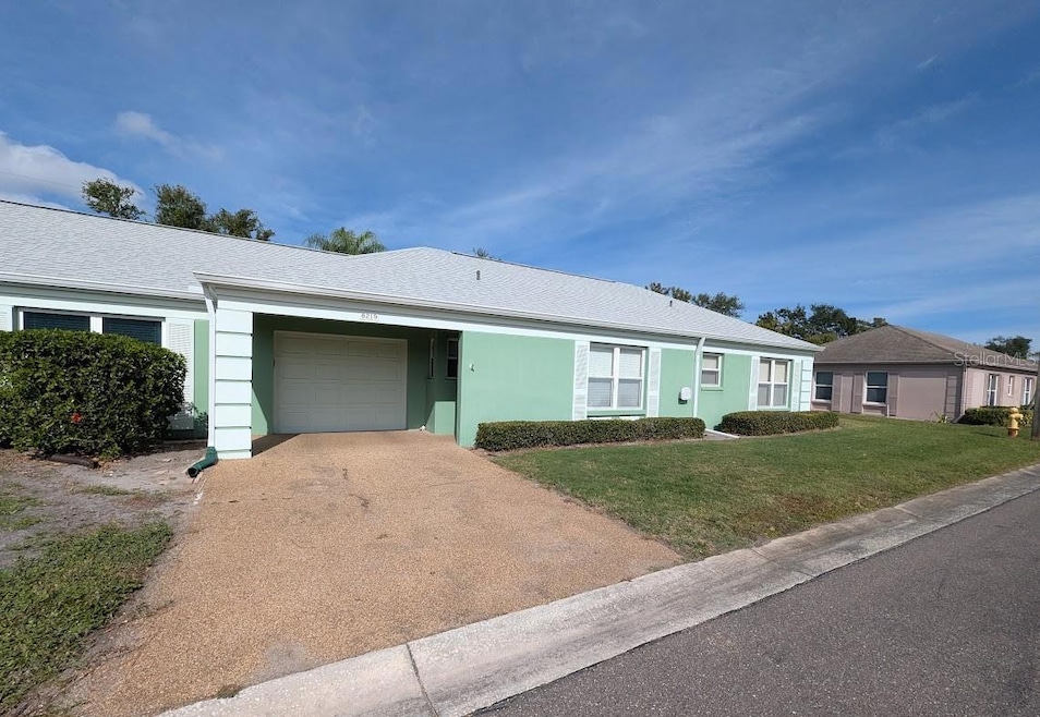 Front exterior with 1 car garage and parking pad