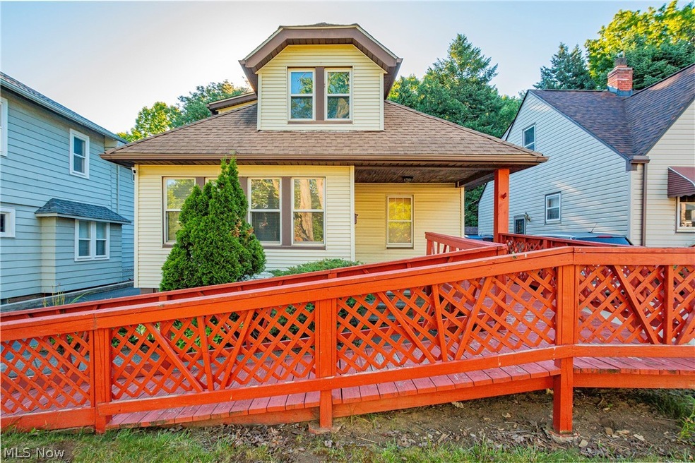 Rear view of property featuring a wooden deck