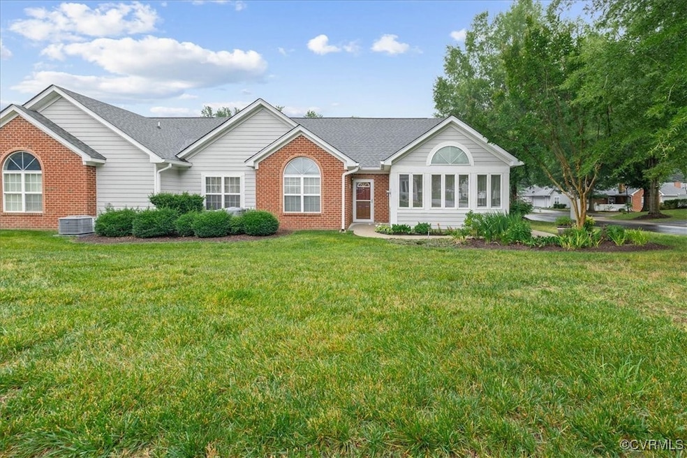 Single story home with brick siding, a front yard,