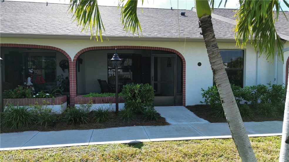 Doorway to property featuring a shingled roof and stucco siding