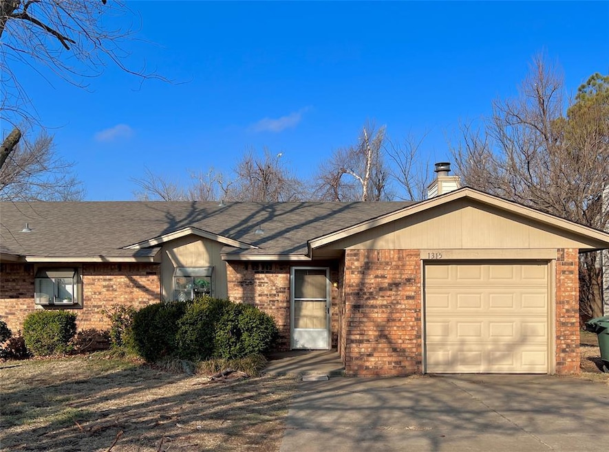 Ranch-style house featuring brick siding, a shingl