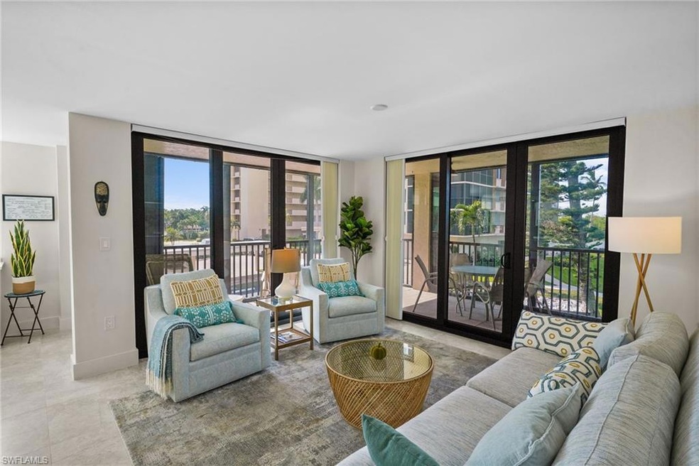 Tiled living area with floor to ceiling windows and baseboards