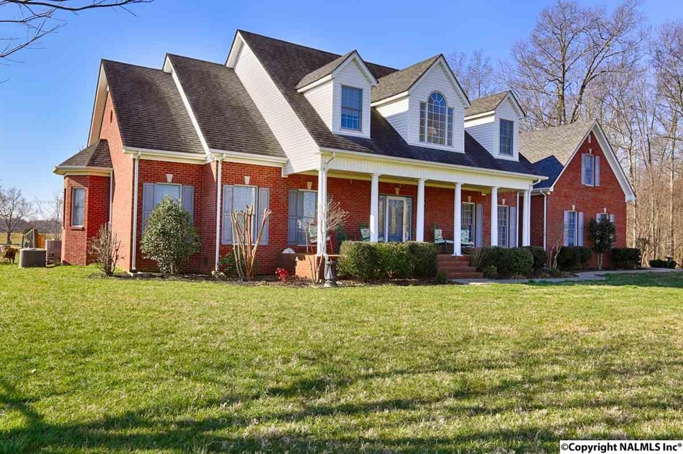 This full brick home is situated on over 26 acres of farm land.