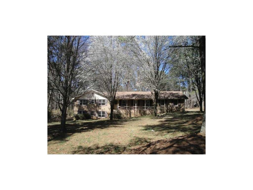 Exterior Front. Brick ranch sits back on a deep lo