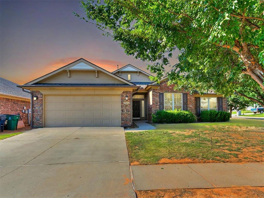 View of front of home with a yard and a garage