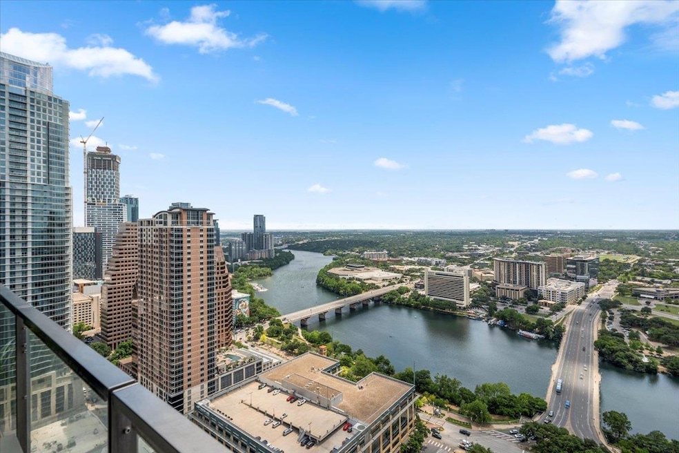 Birds eye view of property with a water view and 
