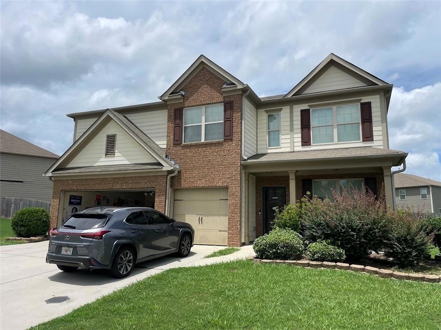 View of front of house with a front lawn and a gar
