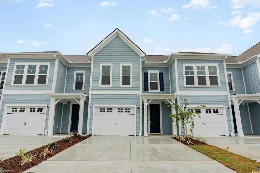 View of front of house with concrete driveway