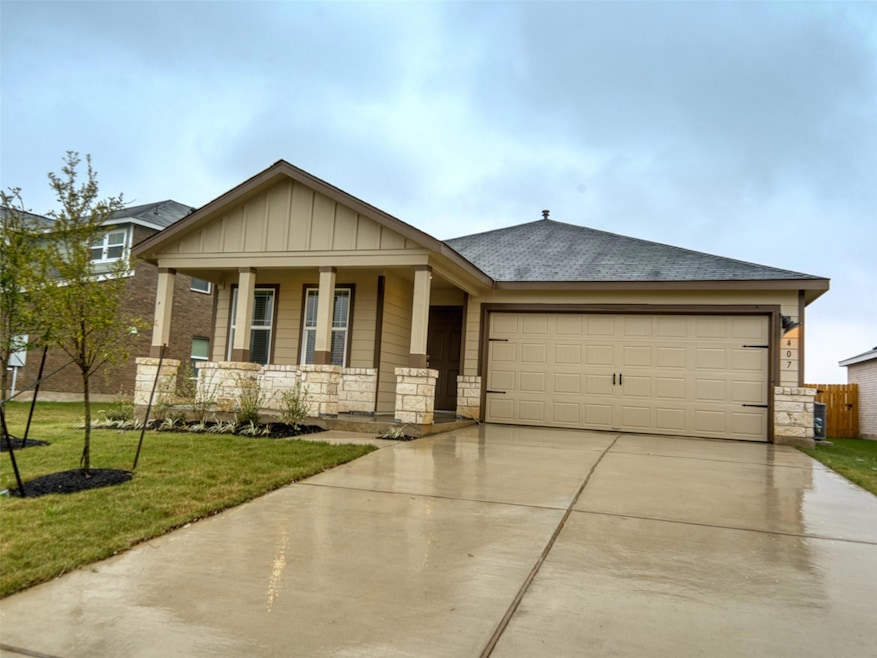 View of front of property featuring a porch, a ga