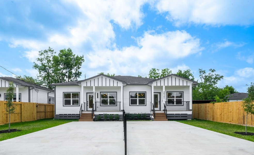 Modern duplex with a clean white exterior and blac