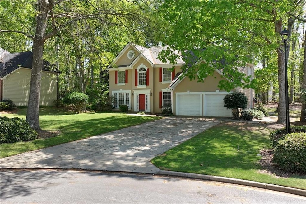 Colonial house featuring concrete driveway, a gara