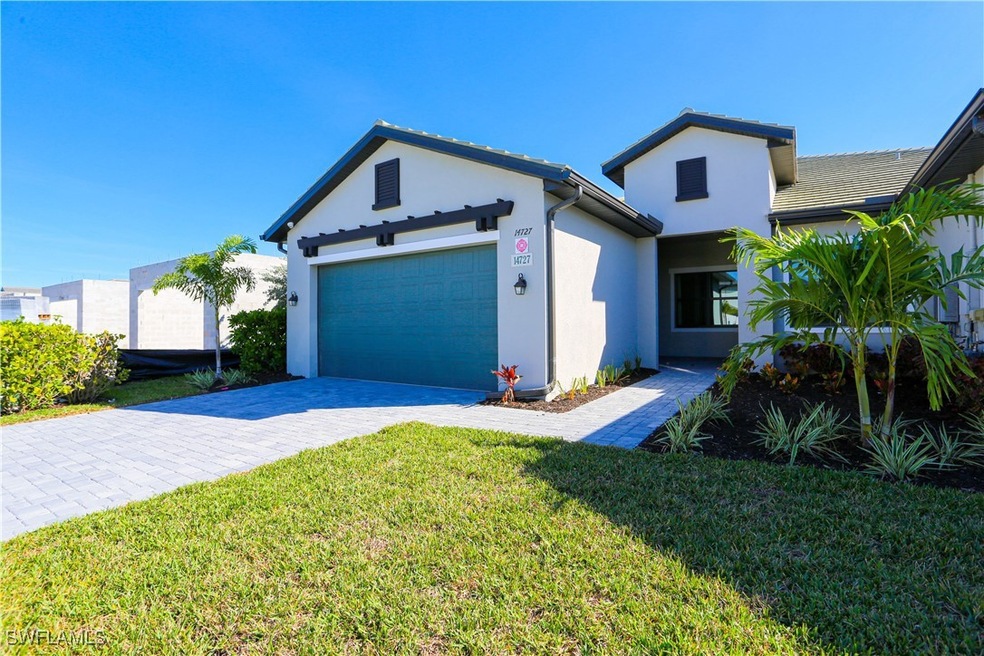 View of front of home with a garage and a front ya