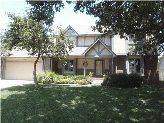 COVERED FRONT PORCH AND TREE SHADED FRONT YARD