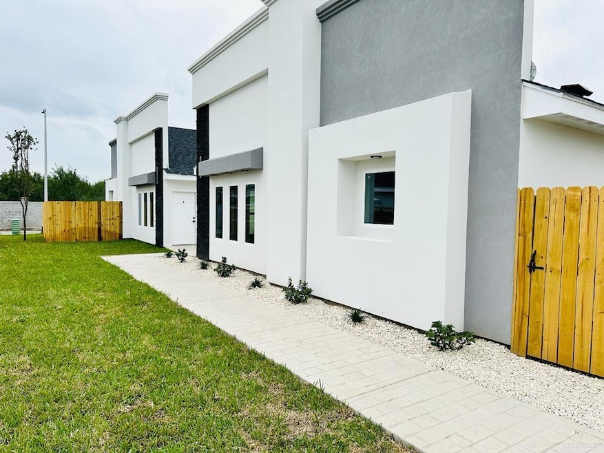 Back of house featuring stucco siding
