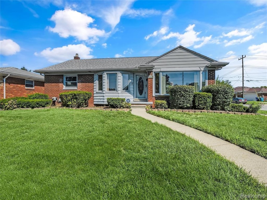 Ranch-style home featuring brick siding, a front lawn, and a chimney