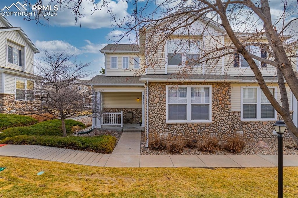 View of front of house with stone siding, roof wit
