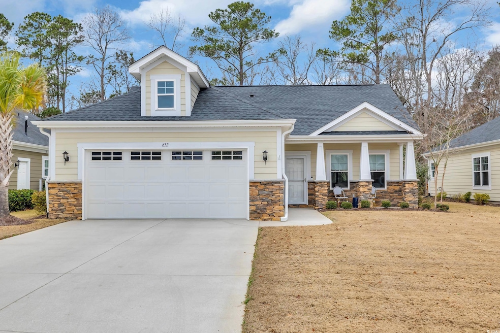 View of front facade with a garage and covered por