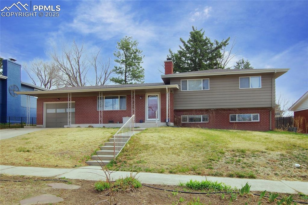 Split level home with an attached garage, a chimne