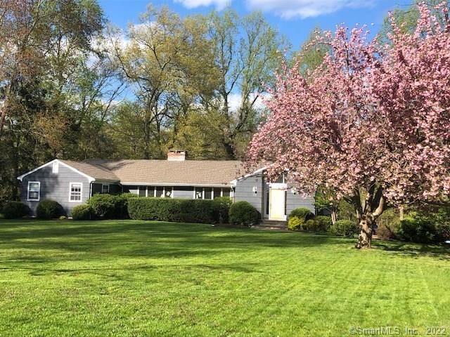 Expansive lawn with blooming Cherry tree at the en