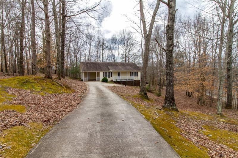Situated at the back of its ~3/4 acre wooded lot a