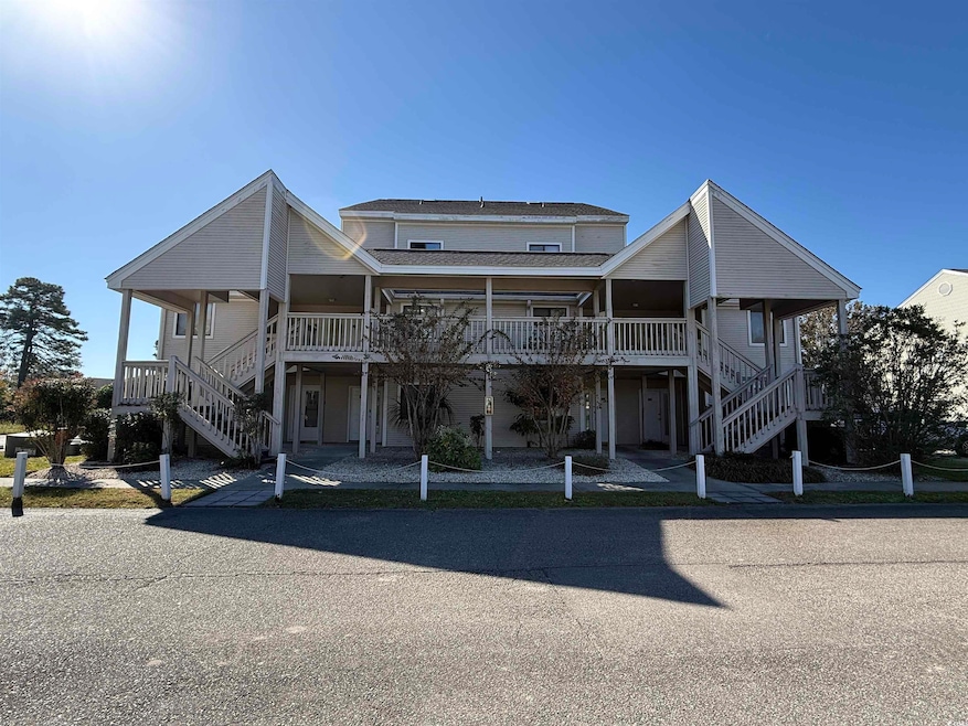 View of front of home featuring stairs and a porch