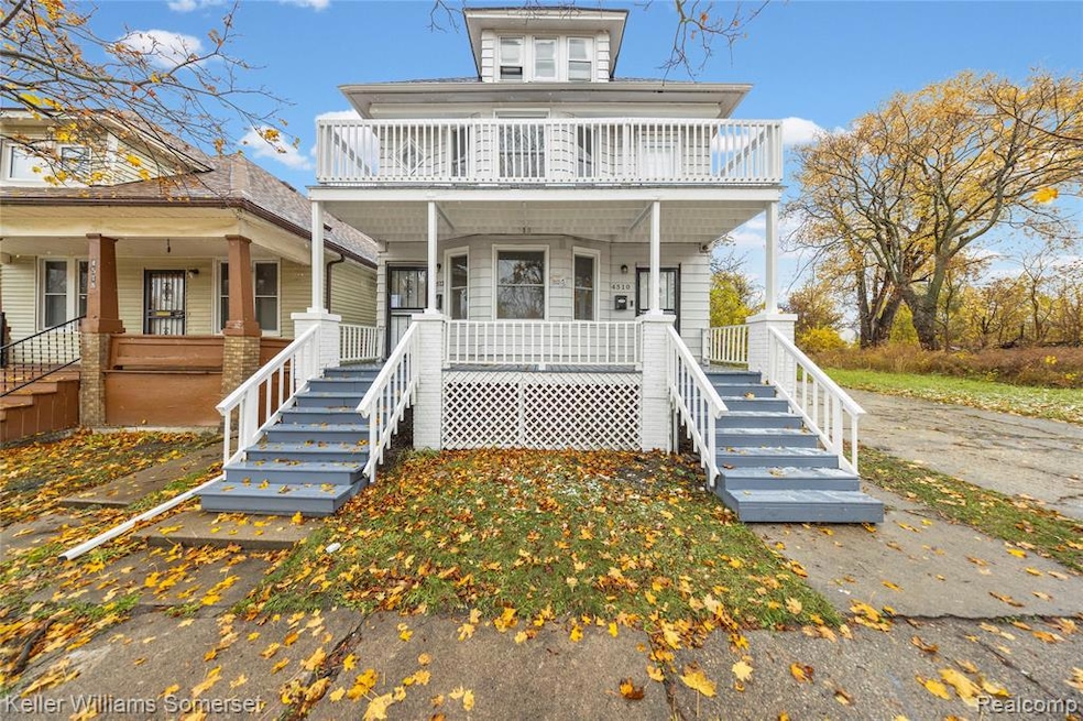 View of front of property featuring covered porch and stairway