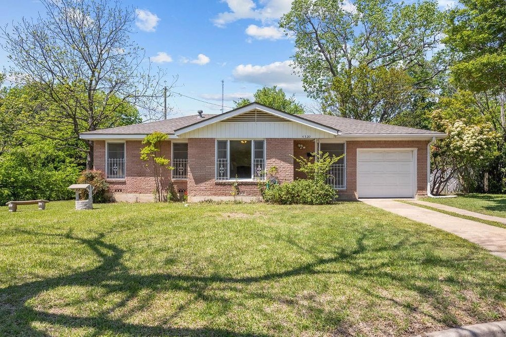 Ranch-style home with concrete driveway, a front y