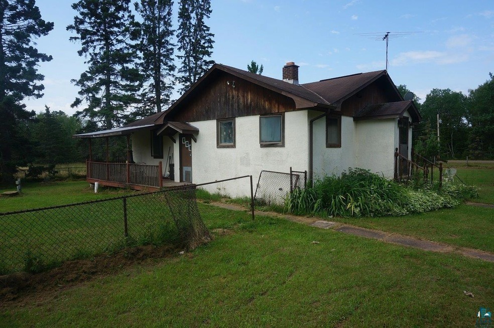 Rear view of property with a lawn