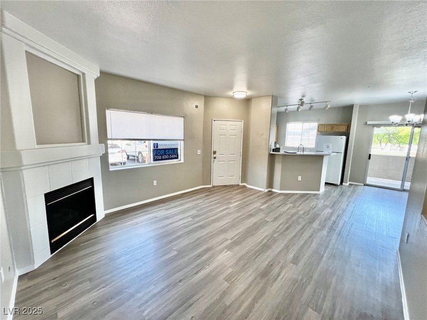 Unfurnished living room featuring a chandelier, a